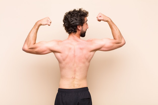 Young cool bearded man back fitness concept