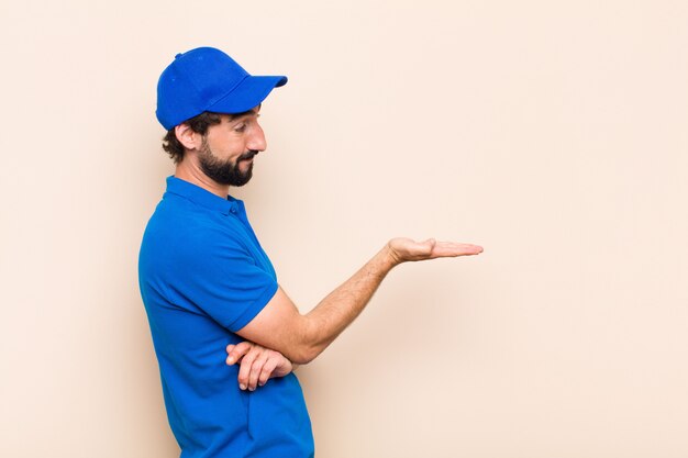 Young cool bearded man pointing to the side