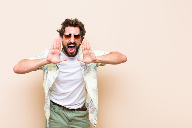 Young cool bearded man shouting