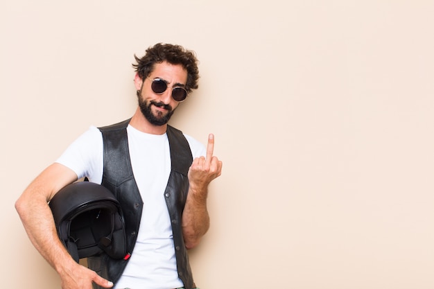 Young cool bearded man with a helmet and angry expression 