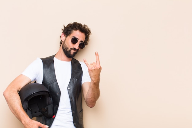 Young cool bearded man with a helmet and angry expression 