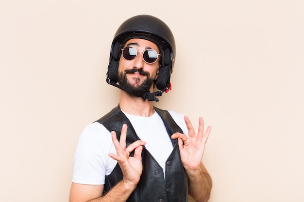 Young cool bearded man with a helmet looking successful