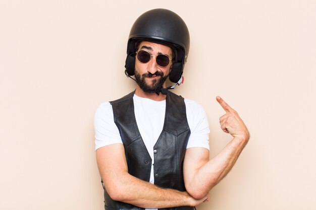 Young cool bearded man with a helmet looking successful