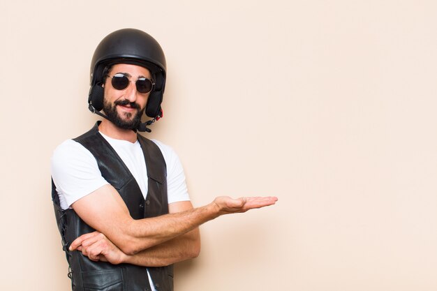 Young cool bearded man with a helmet pointing to the side