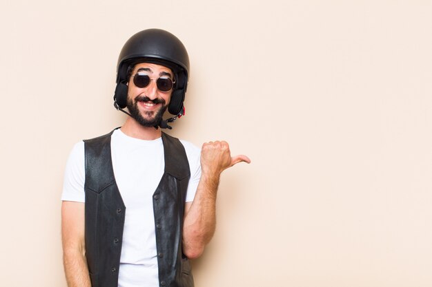 Young cool bearded man with a helmet pointing to the side