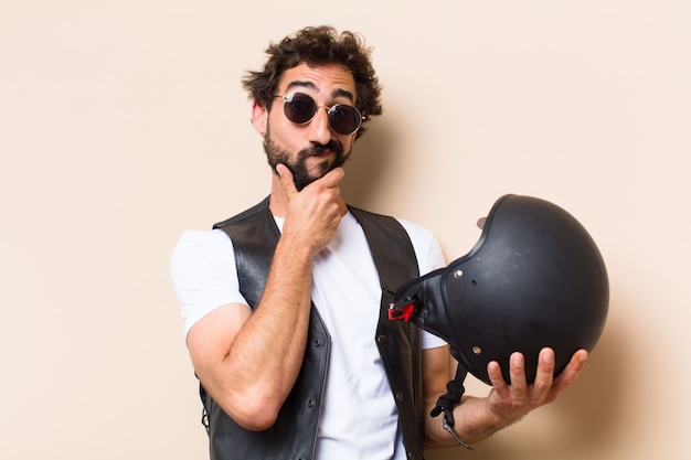 Young cool bearded man with a helmet thinking