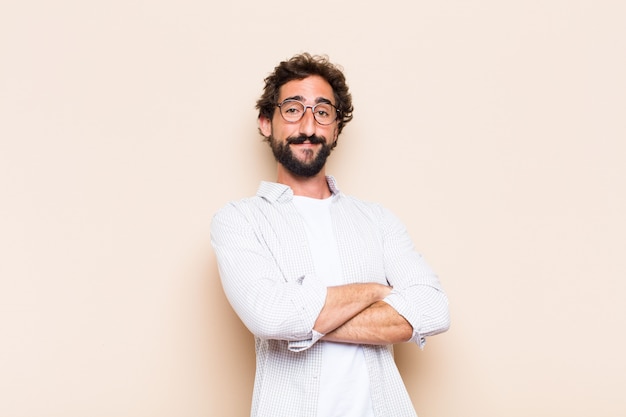 Young cool bearded man with proud and satisfied expression