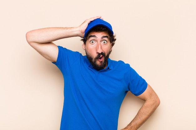 Young cool bearded man with surprise or shock expression