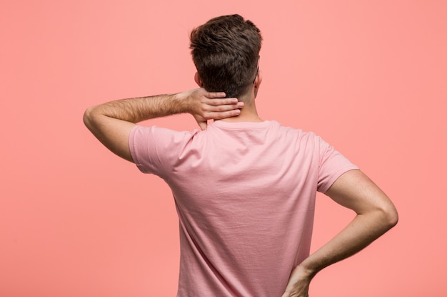 Young cool caucasian man from behind thinking about something.