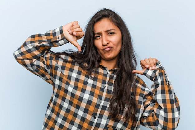 Young cool indian woman feels proud and self confident, example to follow.