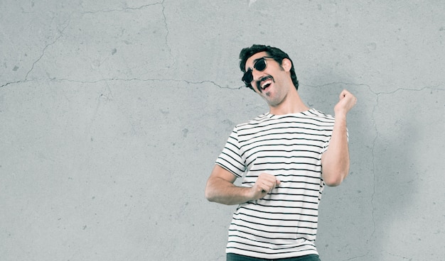 Young cool man against grunge background