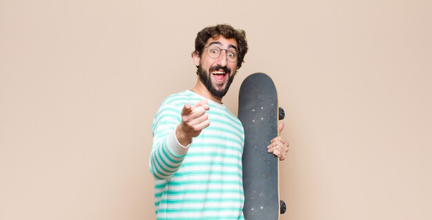 Young cool man bearded with a skate board