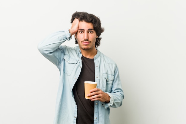 Young cool man drinking a coffee being shocked