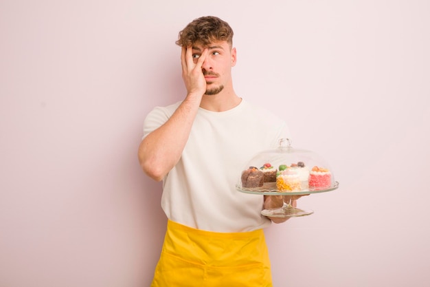 Young cool man feeling bored frustrated and sleepy after a tiresome homemade cakes concept