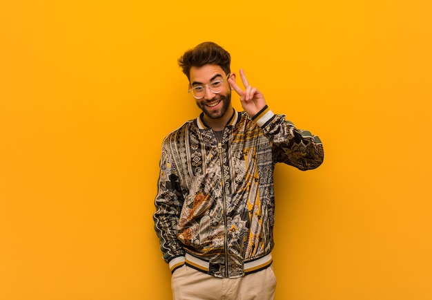 Young cool man fun and happy doing a gesture of victory