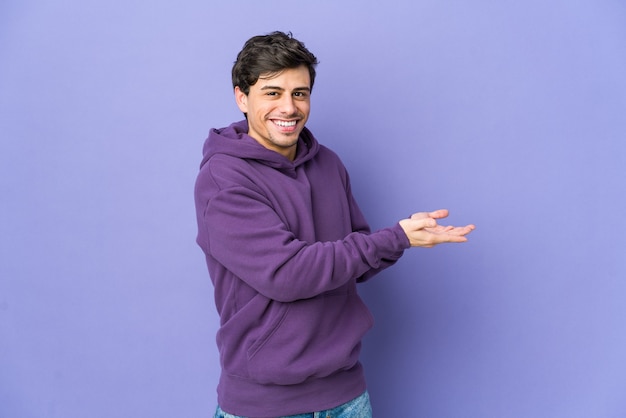 Young cool man holding a copy space on a palm.