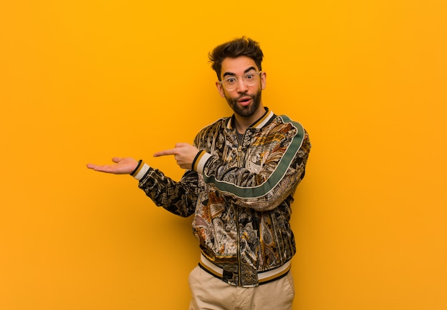 Young cool man holding something with hand