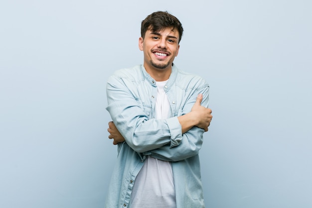 Young cool man hugs, smiling carefree and happy