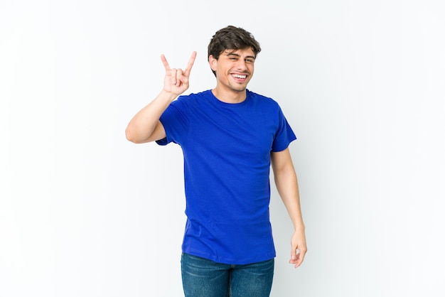 Young cool man showing a horns gesture