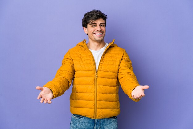 Young cool man showing a welcome expression