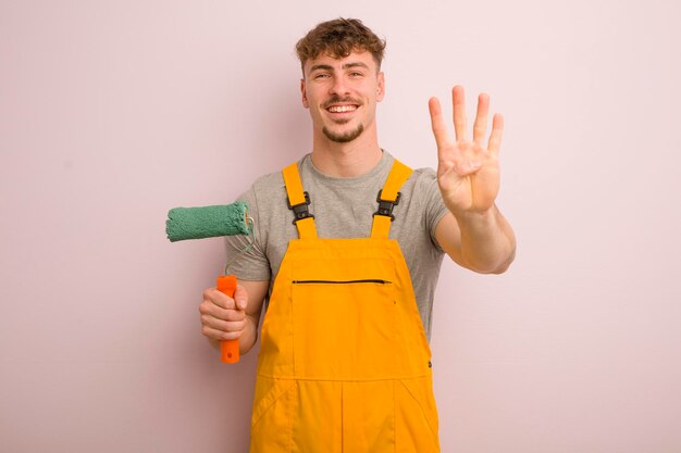 Young cool man smiling and looking friendly showing number four home improvement concept