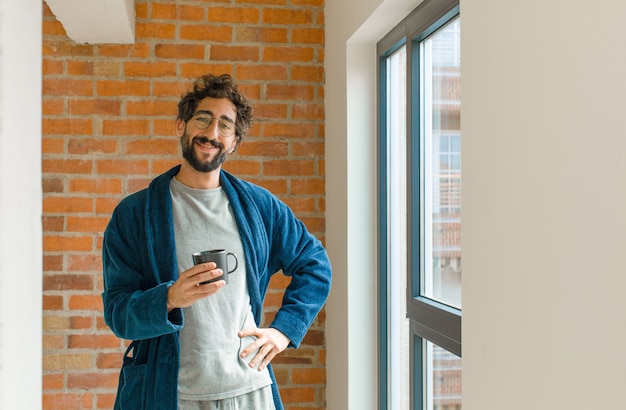 Young cool man waking up at home wearing pajamas