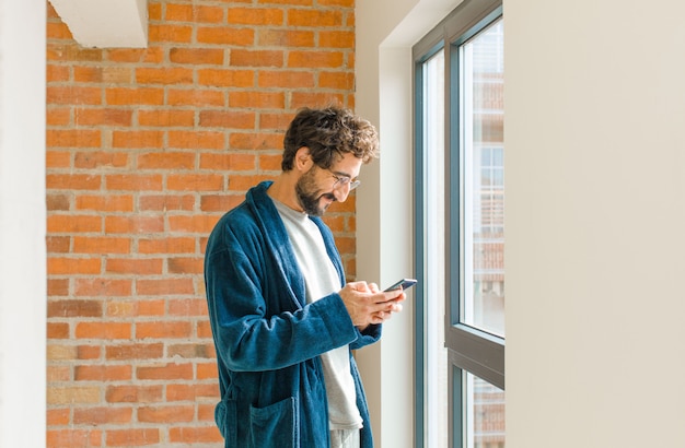 Young cool man waking up at home wearing pajamas