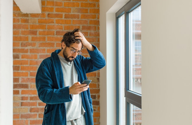 Young cool man waking up at home wearing pajamas