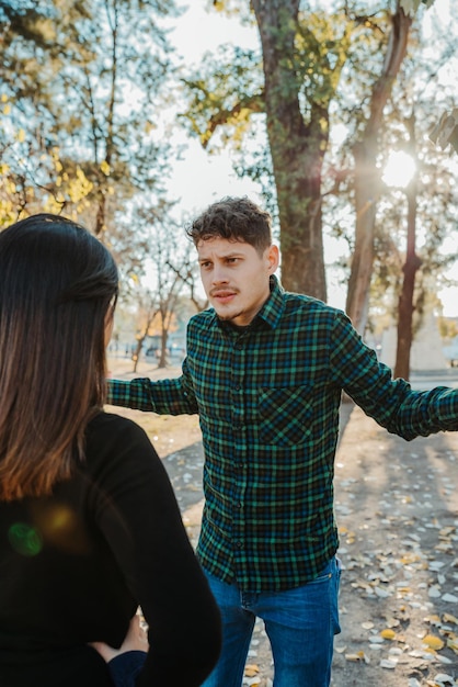 a young couple arguing outdoors