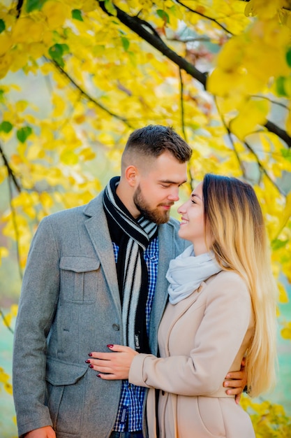 Young couple in autumn season alley