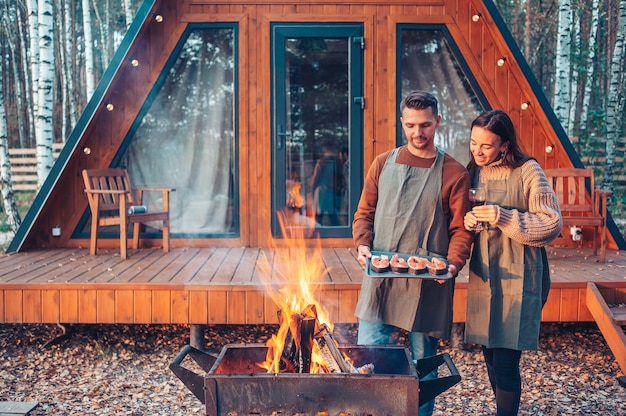 Young couple at autumn warm day grill and relax