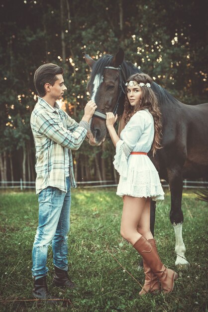 Young couple and beautiful horse