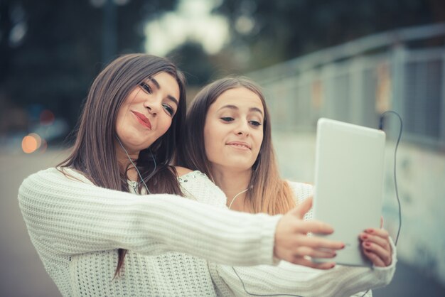 young couple beautiful women girls autumn using tablet