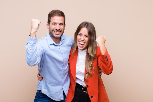 Young couple on beige wall