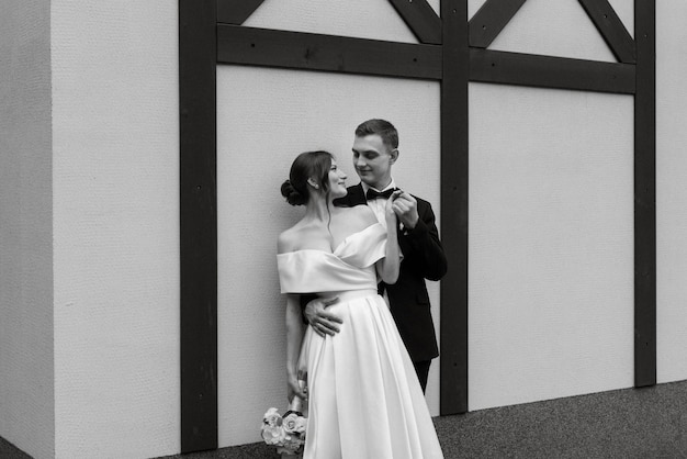 Photo young couple bride and groom in a white short dress