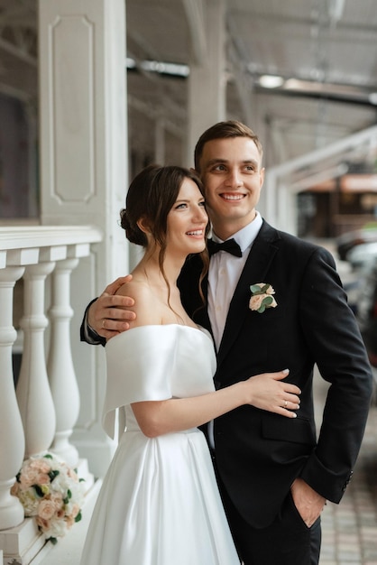 Young couple bride and groom in a white short dress