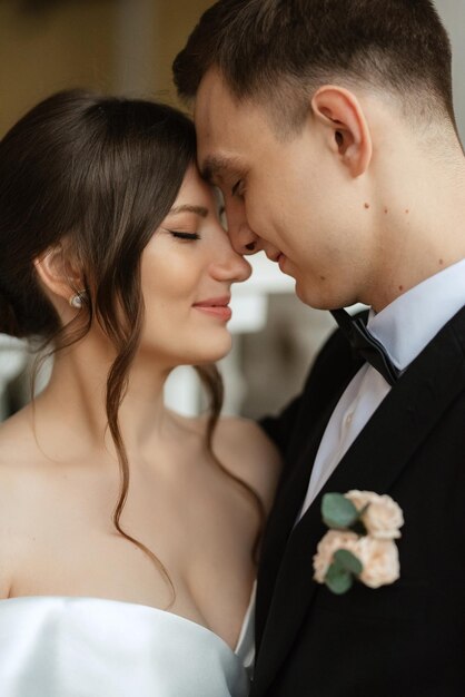 Young couple bride and groom in a white short dress