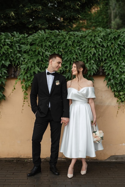 Young couple bride and groom in a white short dress