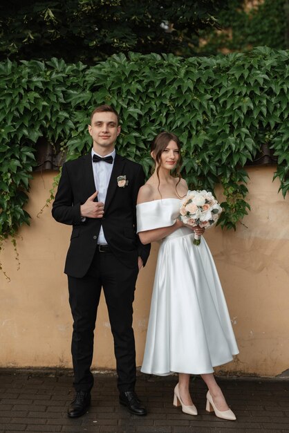 Young couple bride and groom in a white short dress