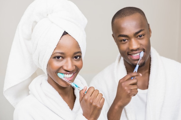 Young couple brushing teeth