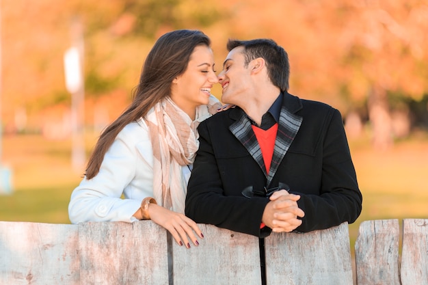 Young couple by the fence