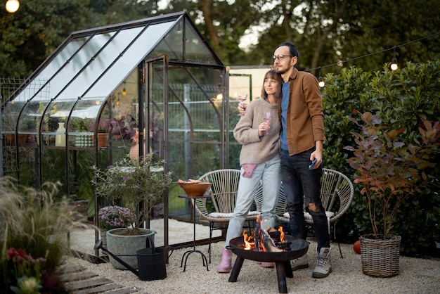 Young couple by the fire at backyard