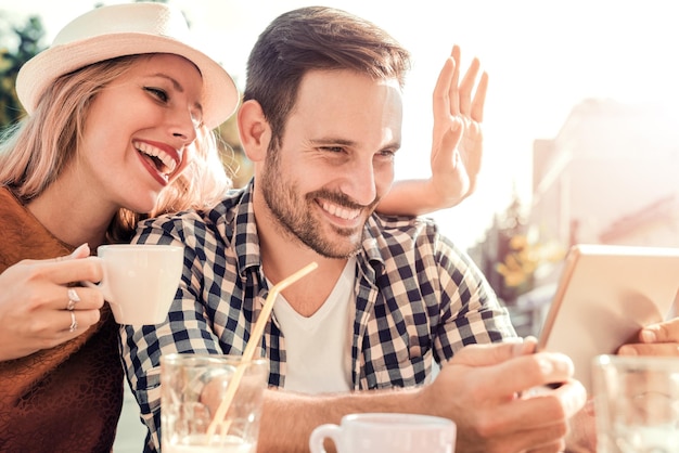 Young couple in cafe laughing