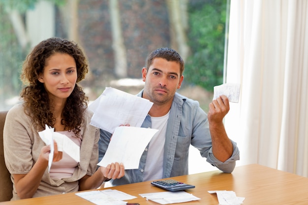 Young couple calculating their domestic bills