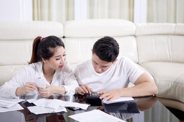 Young couple calculating their household finance