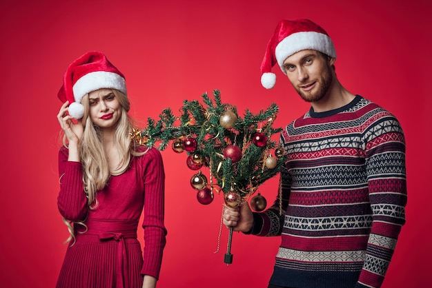 Young couple celebrate christmas together decoration red background