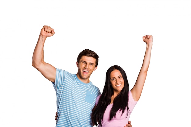 Young couple cheering at camera