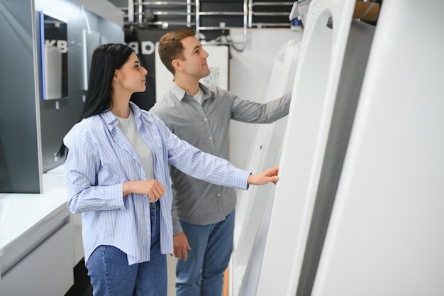 Young couple choosing new bathroom furniture