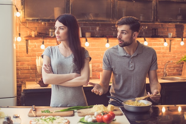 Young couple cooking in kitchen