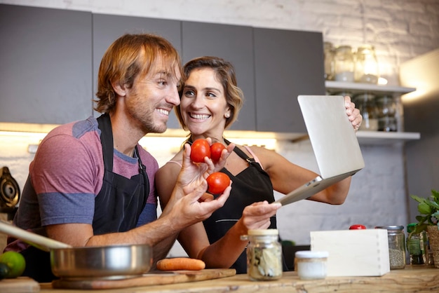 Photo young couple cooking and sharing online cooking tutorial